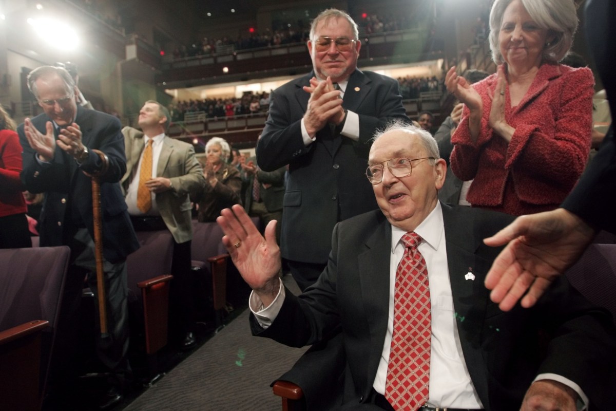 Jesse Helms receives applause after being acknowledged by President Bush during a visit to Raleigh. 