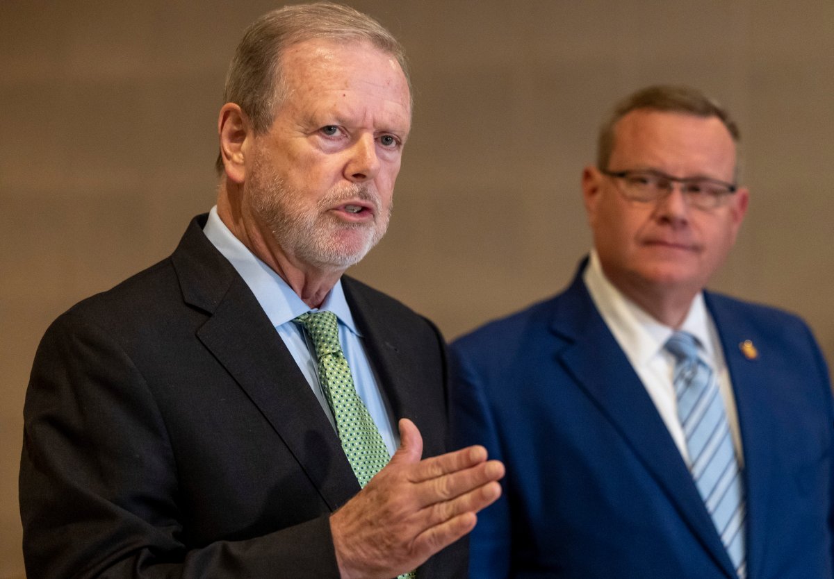 Phil Berger speaks at a presser while Tim Moore watches from behind him