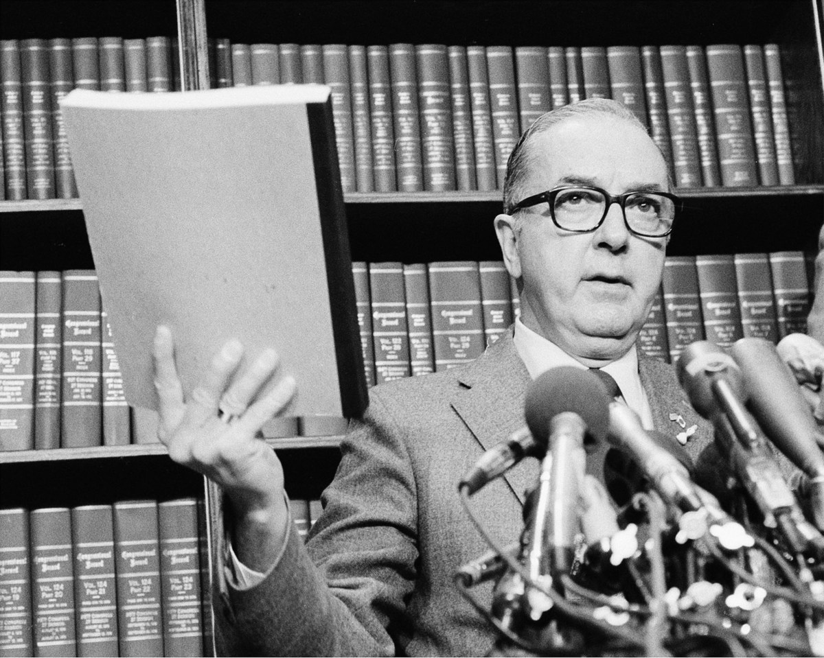 jesse helms speaks at a microphone
